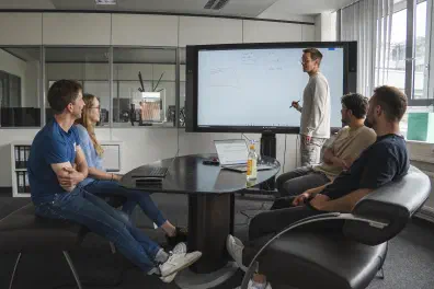 Two people at a whiteboard discussing a problem