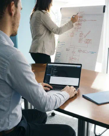 Two people in an office discussing architecture